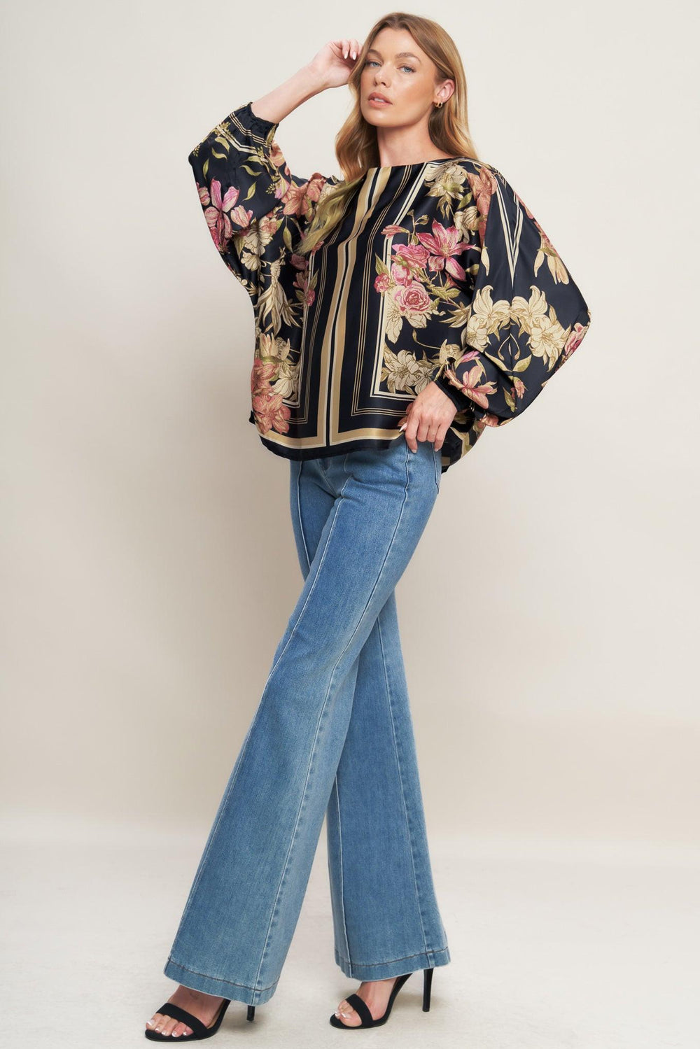 A printed woven top with wide neckline and long sleeve