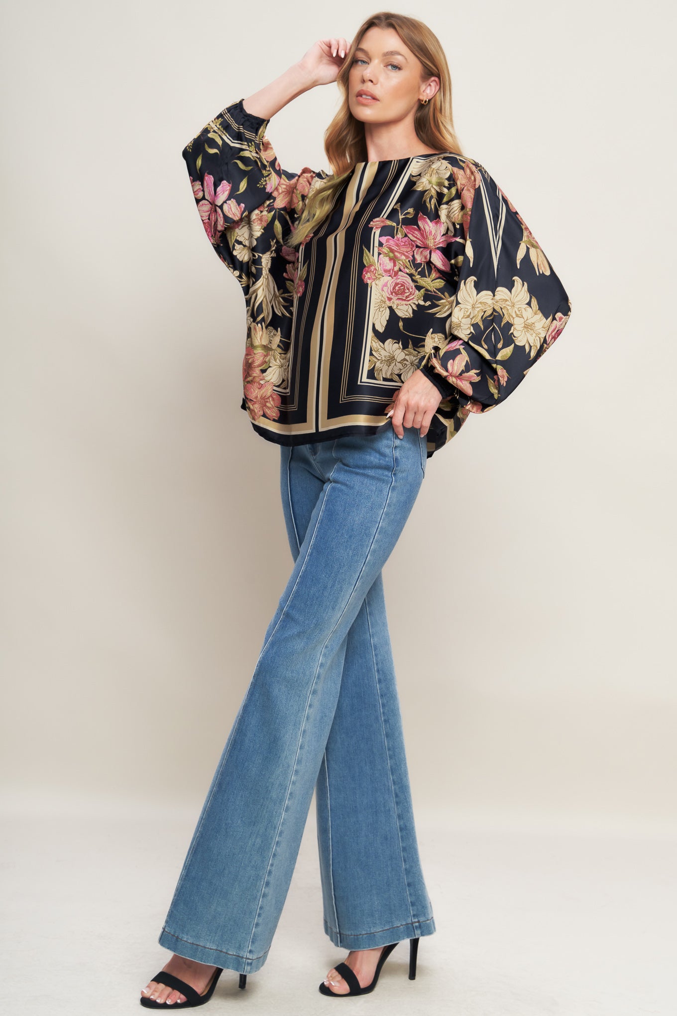 A printed woven top with wide neckline and long sleeve