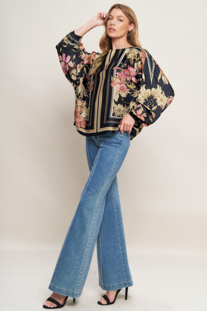 A printed woven top with wide neckline and long sleeve