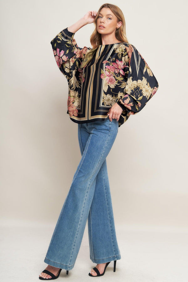 A printed woven top with wide neckline and long sleeve