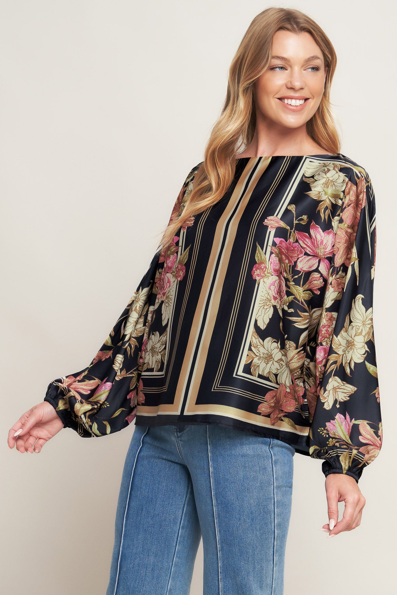 A printed woven top with wide neckline and long sleeve