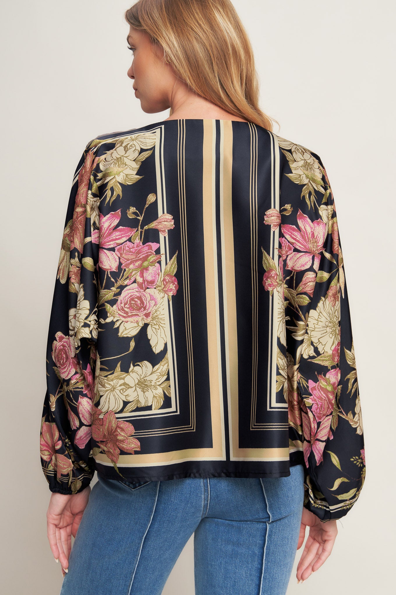 A printed woven top with wide neckline and long sleeve