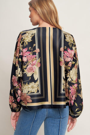 A printed woven top with wide neckline and long sleeve