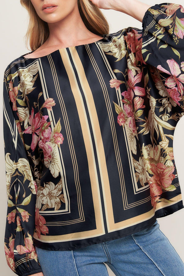 A printed woven top with wide neckline and long sleeve