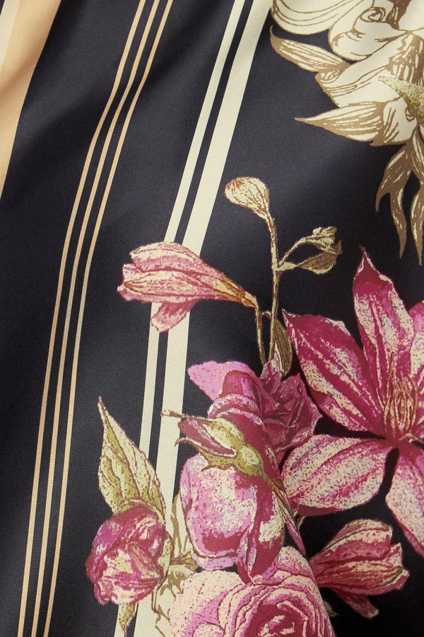 A printed woven top with wide neckline and long sleeve