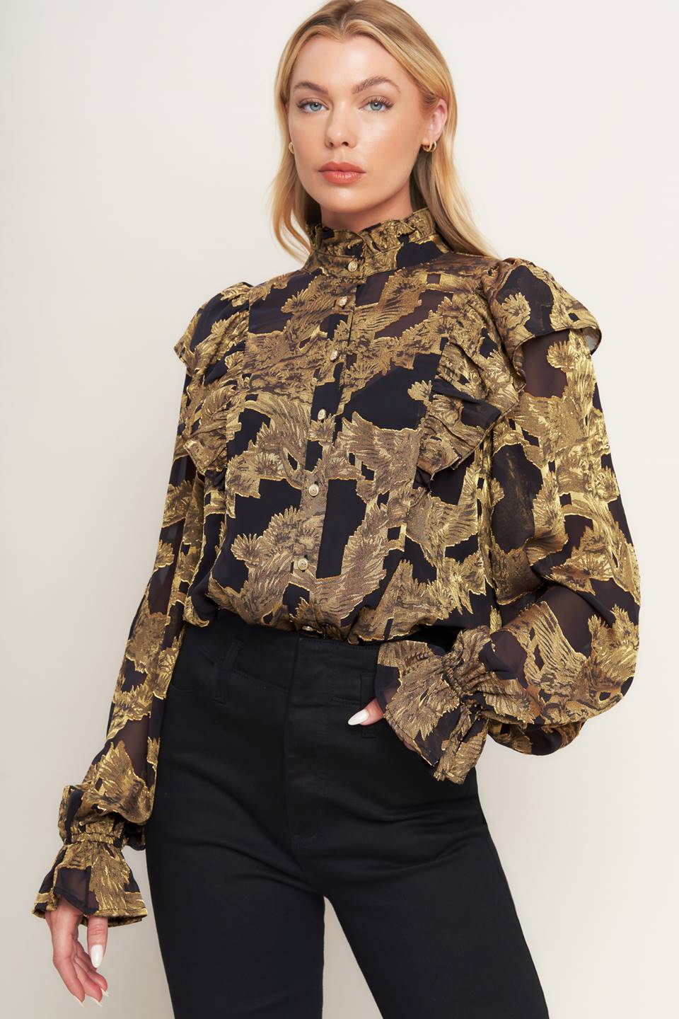 A jacquard woven top featuring high ruffled neckline, front button down, ruffle over shoulder and long sleeve with ruffled cuff