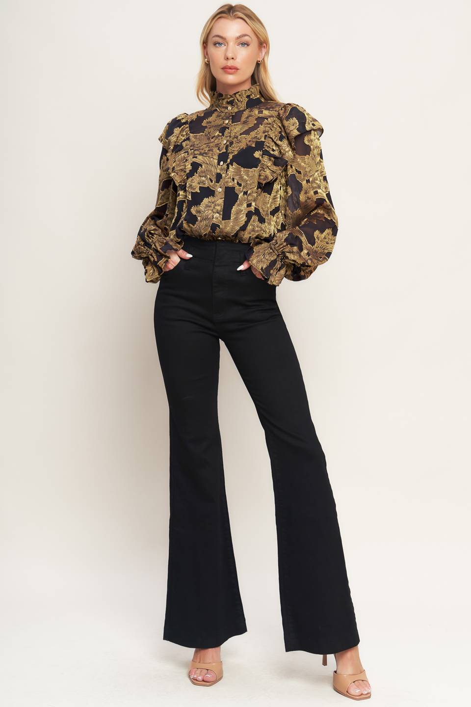 A jacquard woven top featuring high ruffled neckline, front button down, ruffle over shoulder and long sleeve with ruffled cuff
