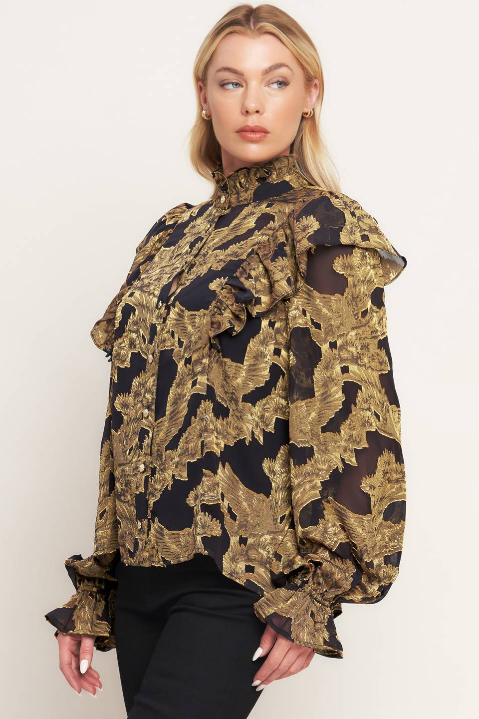 A jacquard woven top featuring high ruffled neckline, front button down, ruffle over shoulder and long sleeve with ruffled cuff