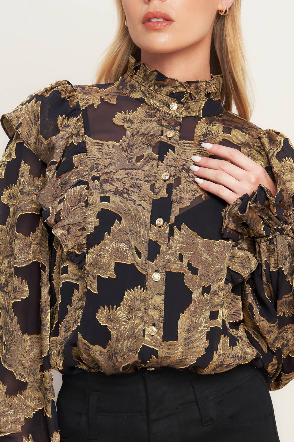 A jacquard woven top featuring high ruffled neckline, front button down, ruffle over shoulder and long sleeve with ruffled cuff
