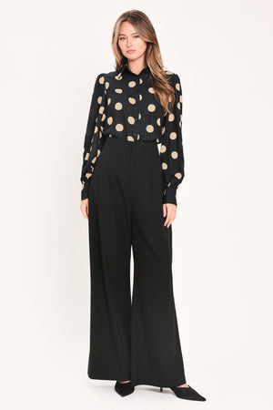 A woman wearing a polka dot printed woven top featuring collar, long sleeve with button down closure | Flying Tomato