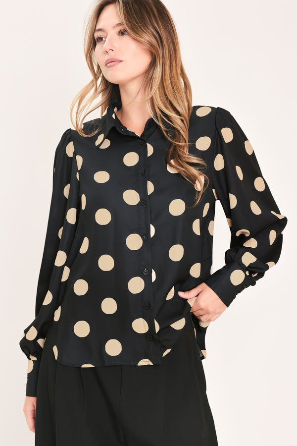 A woman wearing a polka dot printed woven top featuring collar, long sleeve with button down closure | Flying Tomato