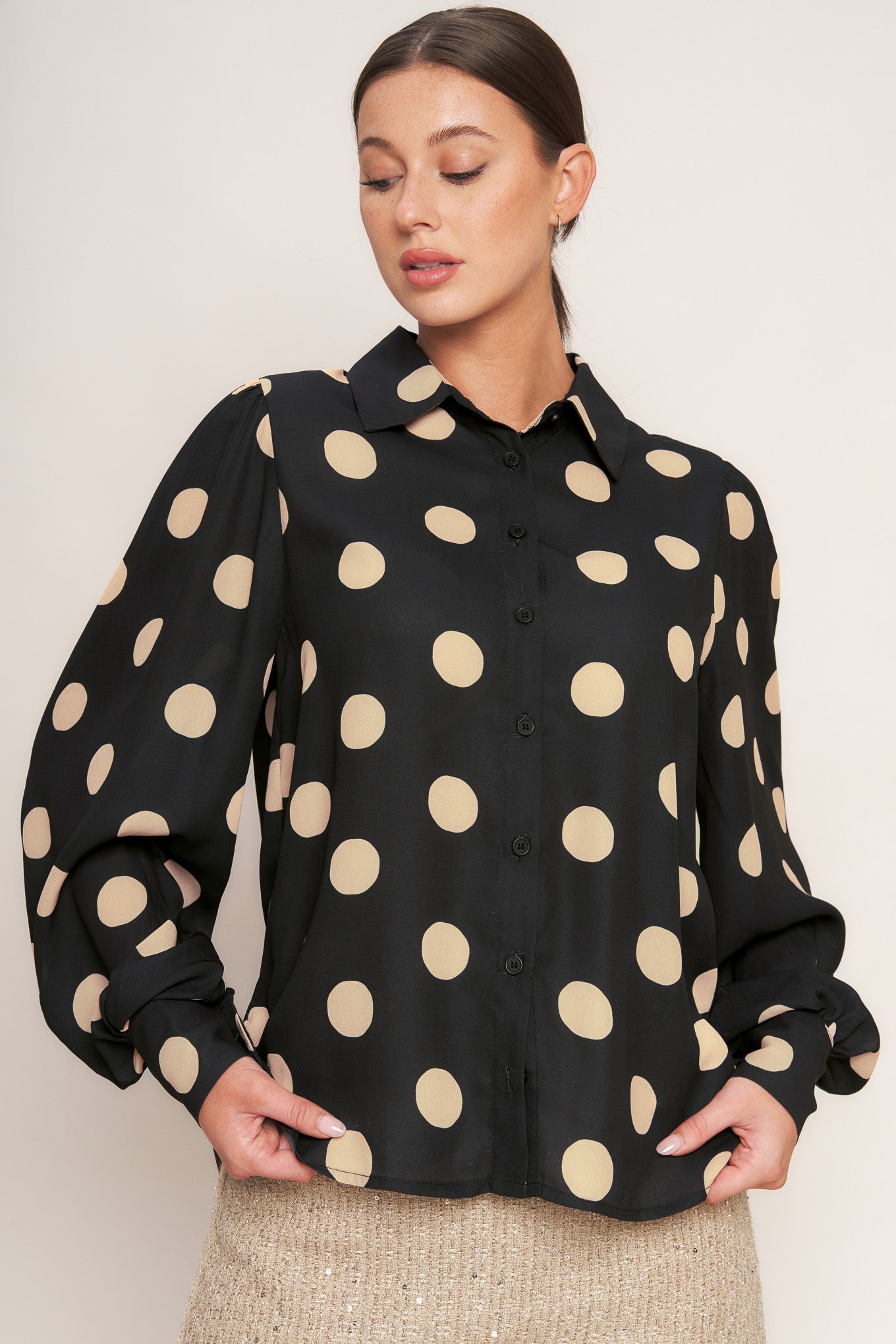 A printed woven top featuring collar, long sleeve with button down closure.