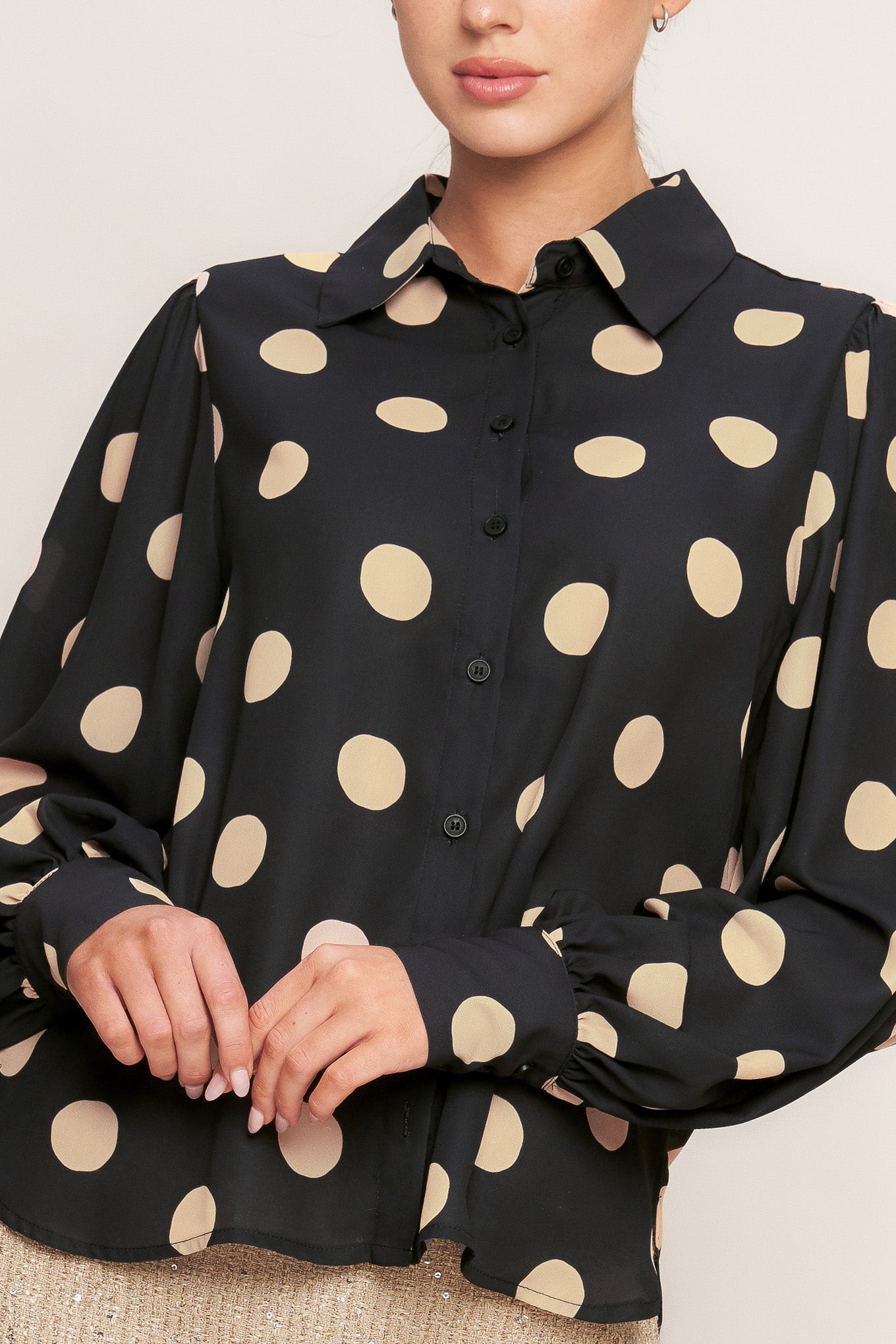 A printed woven top featuring collar, long sleeve with button down closure.
