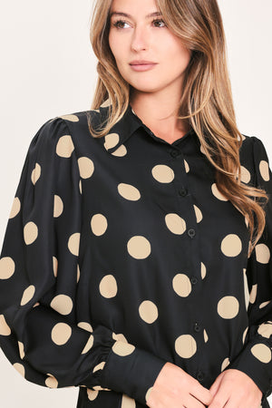 A woman wearing a polka dot printed woven top featuring collar, long sleeve with button down closure | Flying Tomato