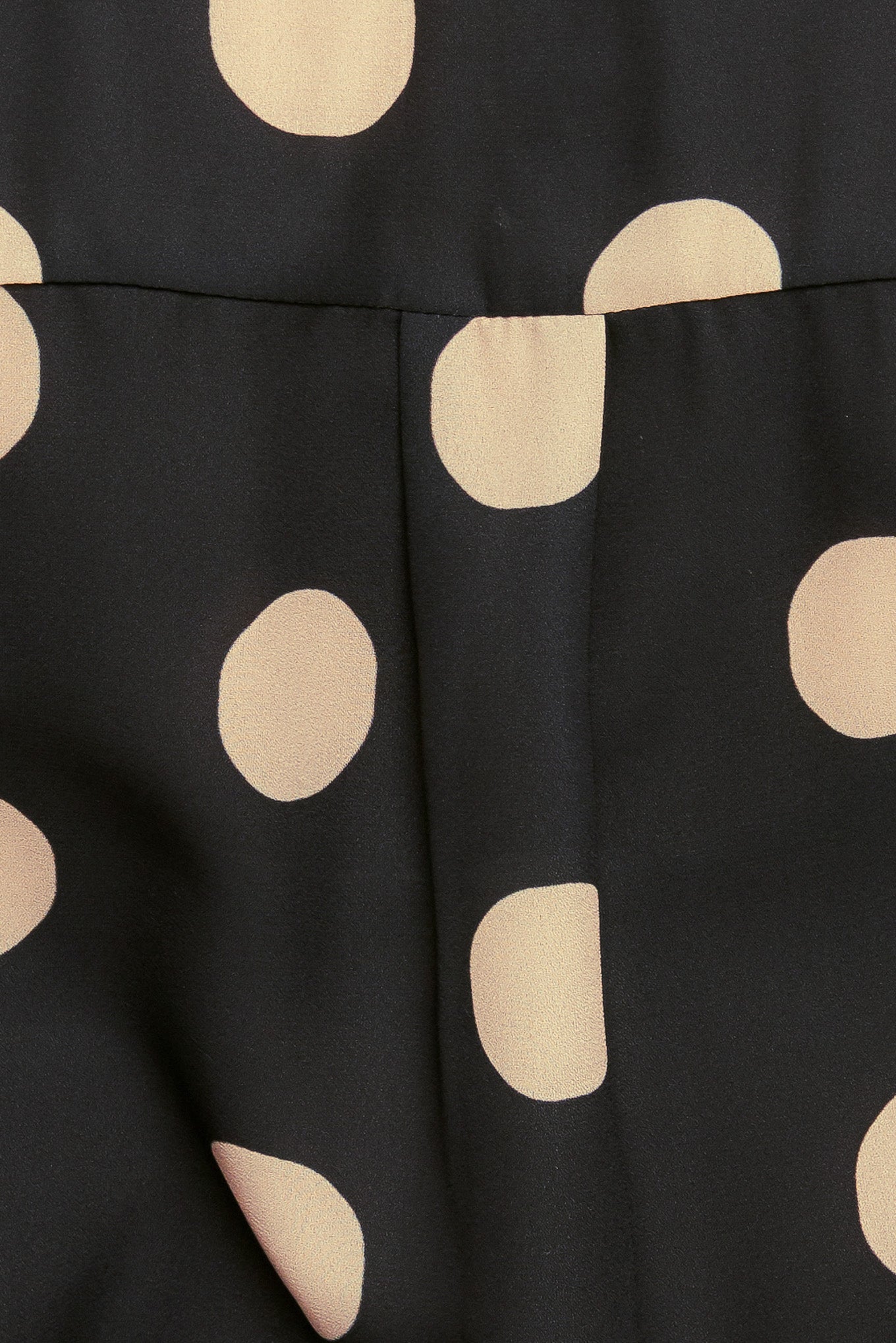 A printed woven top featuring collar, long sleeve with button down closure.
