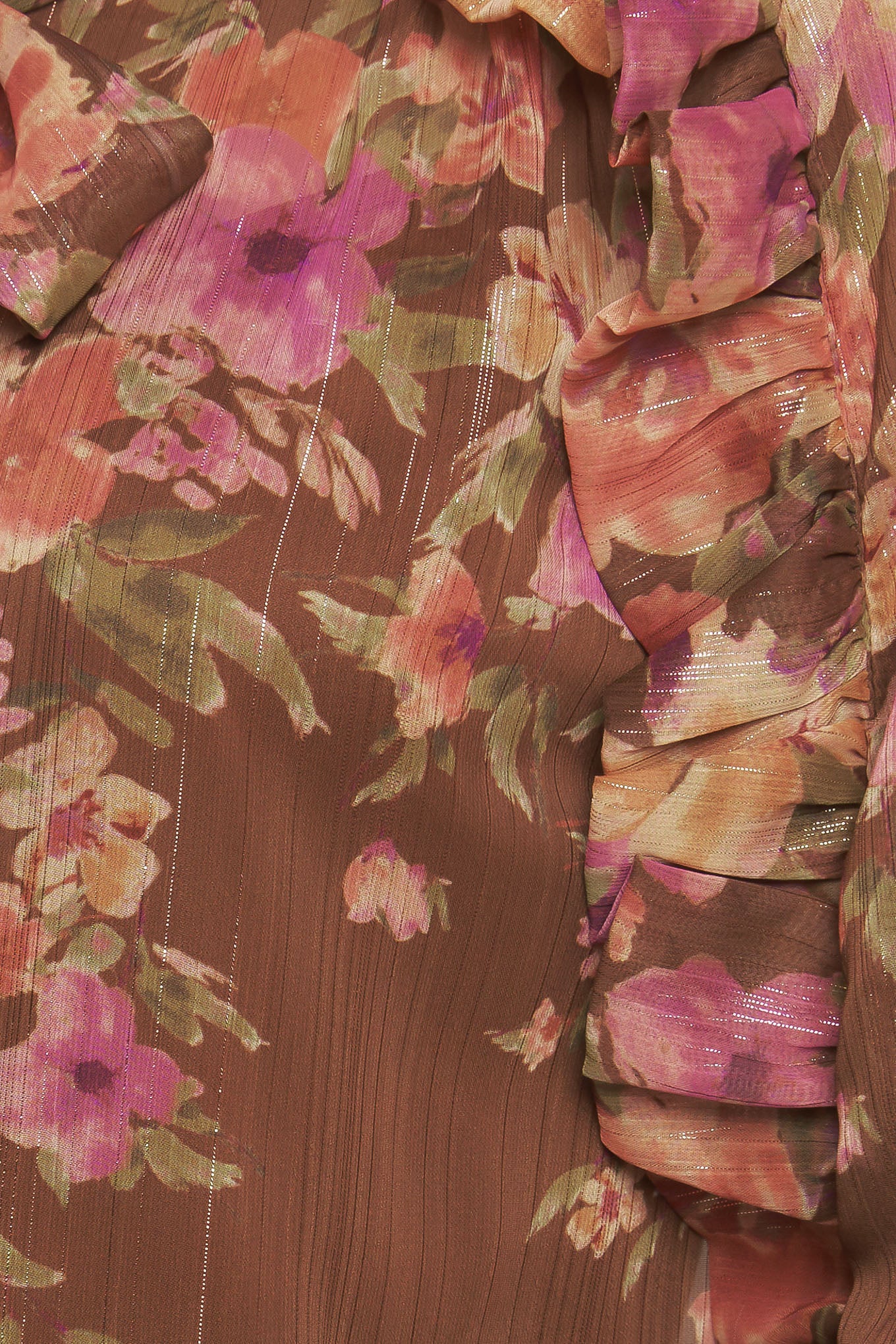 A printed woven top featuring front bow tie, long sleeve with smocked cuff and front button down closure