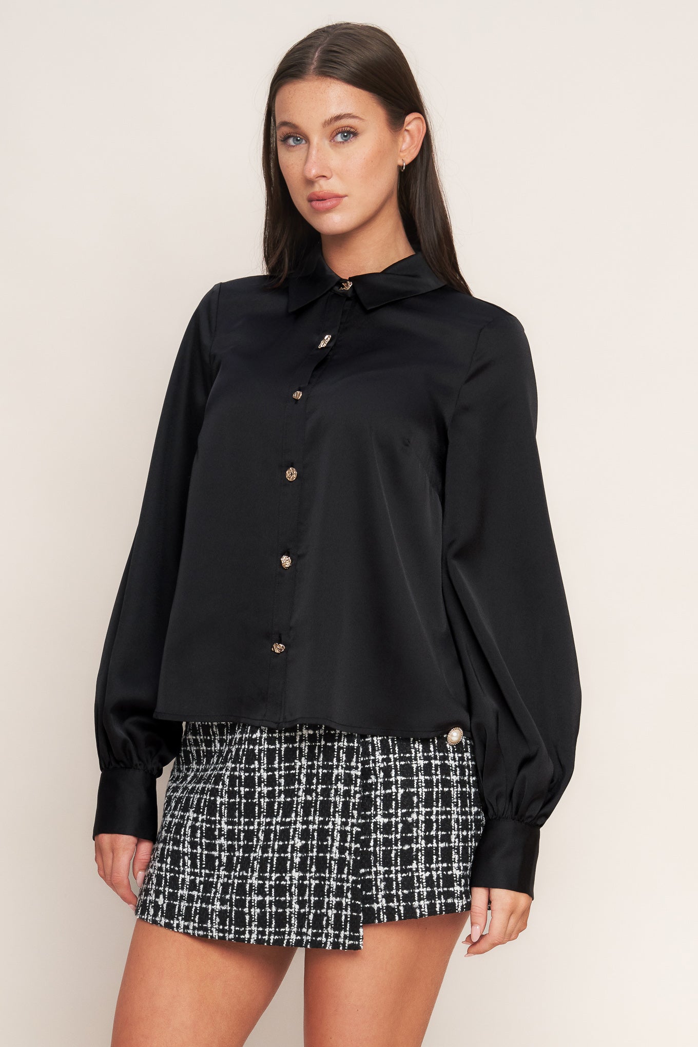 A solid woven top featuring collar, button down and long blouson sleeve with cuff