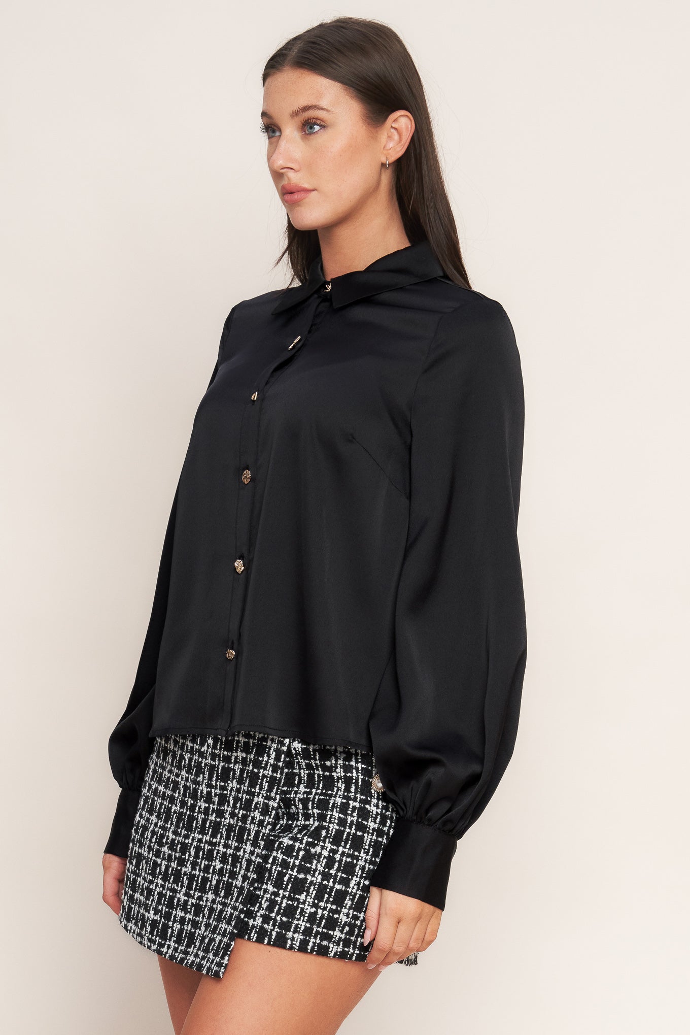 A solid woven top featuring collar, button down and long blouson sleeve with cuff