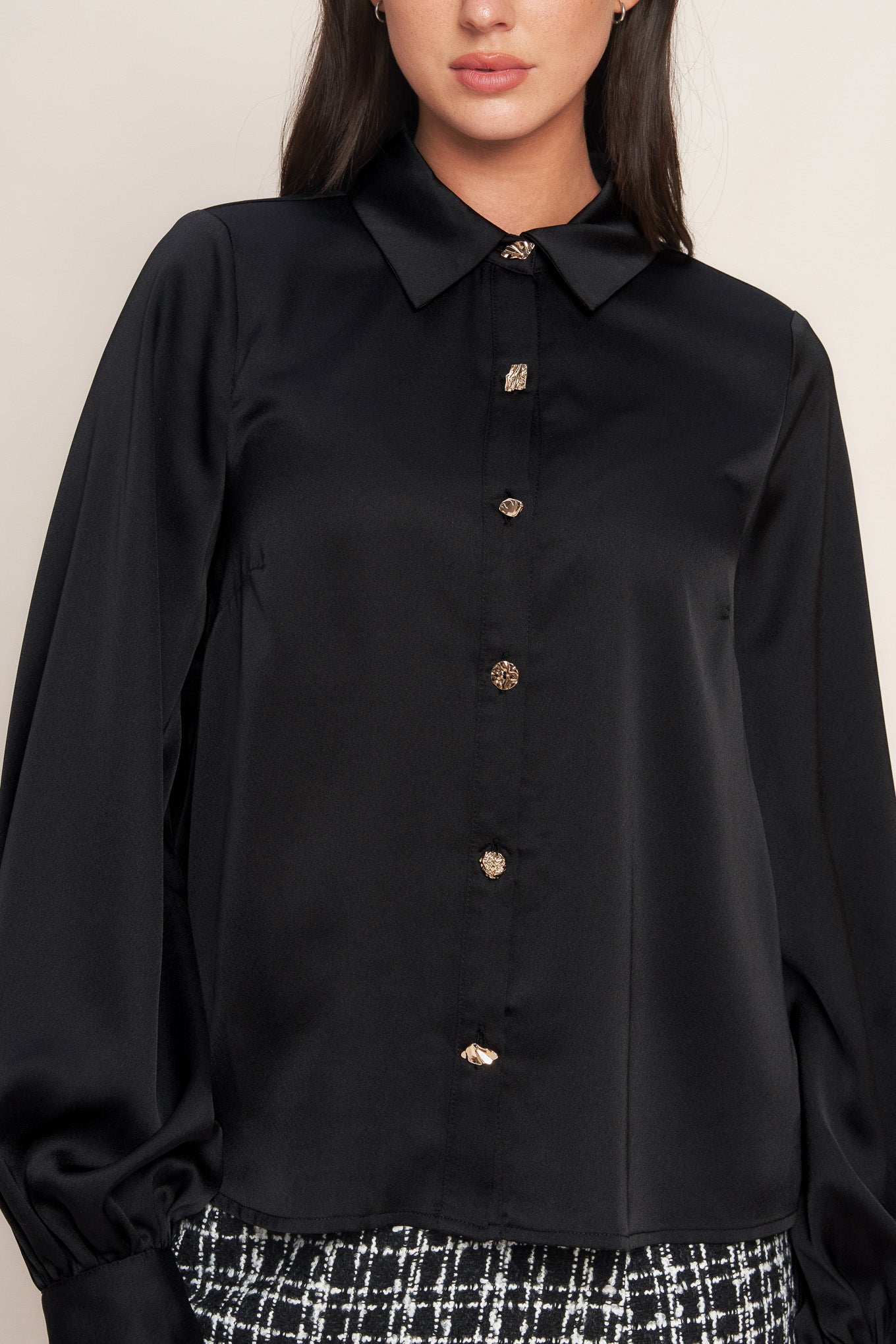 A solid woven top featuring collar, button down and long blouson sleeve with cuff