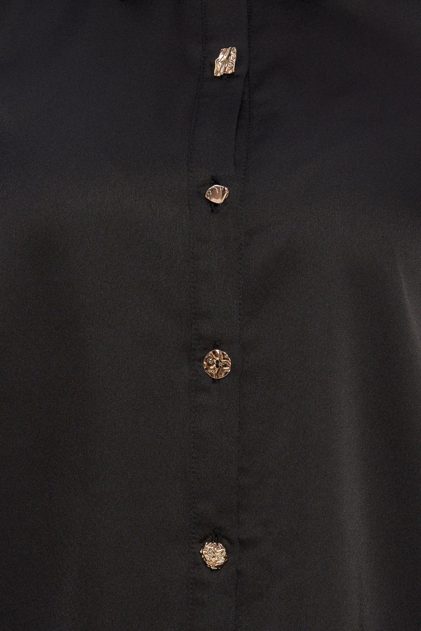 A solid woven top featuring collar, button down and long blouson sleeve with cuff