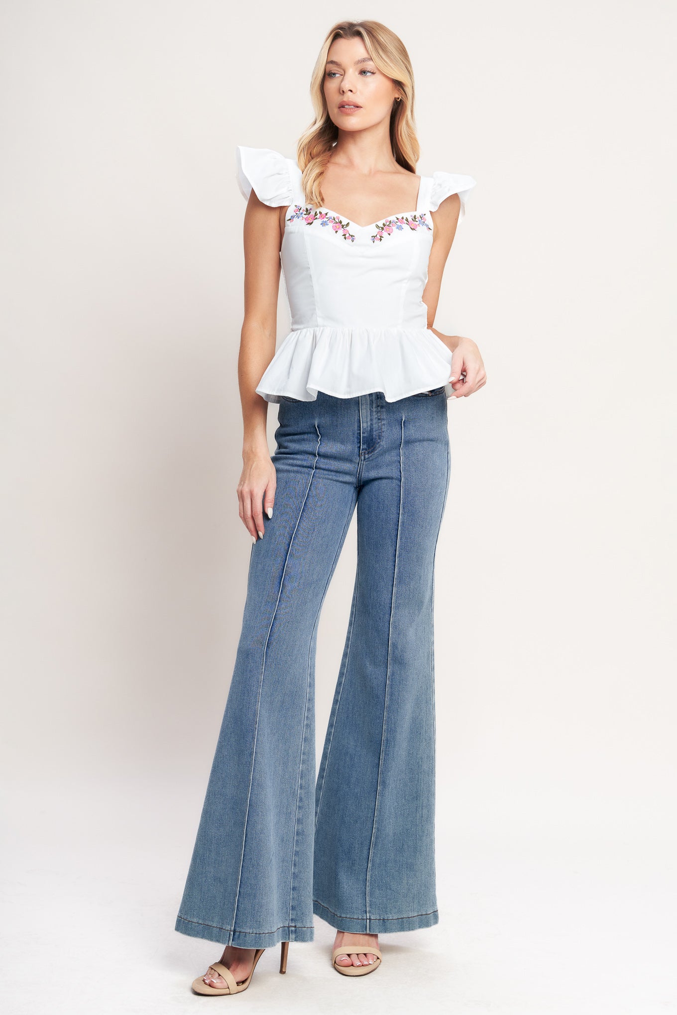 A solid woven top featuring sweetheart neckline, short ruffle sleeve, front embroidery detail, peplum and smocked back bodice

Details:

Self: 100% Cotton Lining : 100% Polyester

Size & Fit

-Model is 5`8" And Wearing Size Small
-Measurements Taken From Size Small
-Approx. Length: 21"