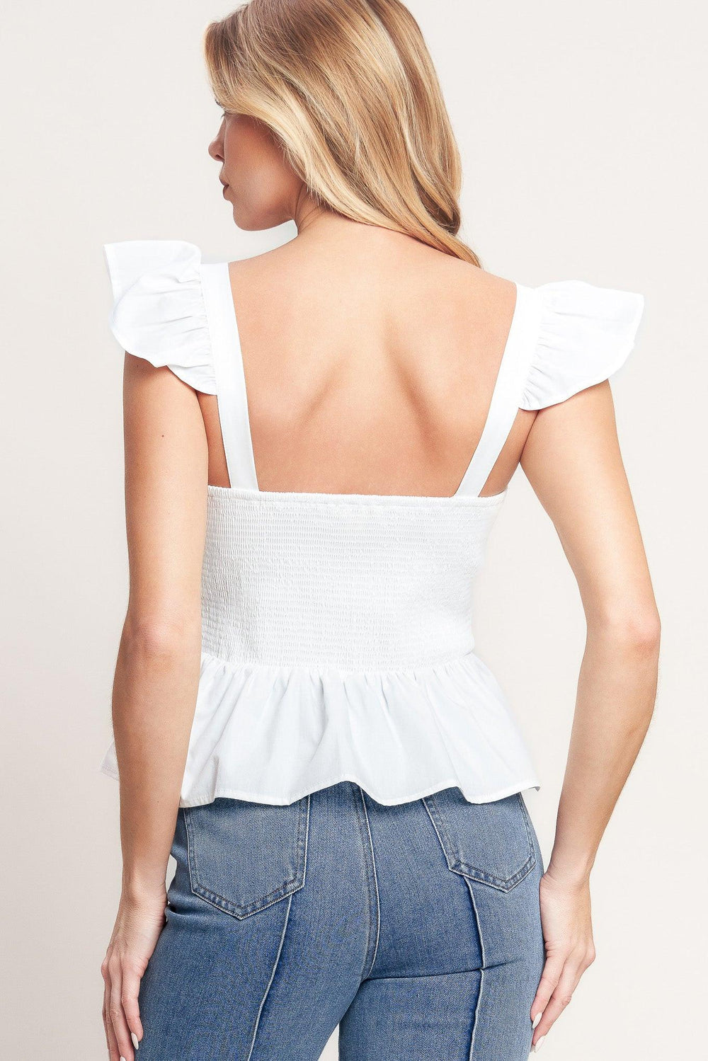 A solid woven top featuring sweetheart neckline, short ruffle sleeve, front embroidery detail, peplum and smocked back bodice

Details:

Self: 100% Cotton Lining : 100% Polyester

Size & Fit

-Model is 5`8" And Wearing Size Small
-Measurements Taken From Size Small
-Approx. Length: 21"