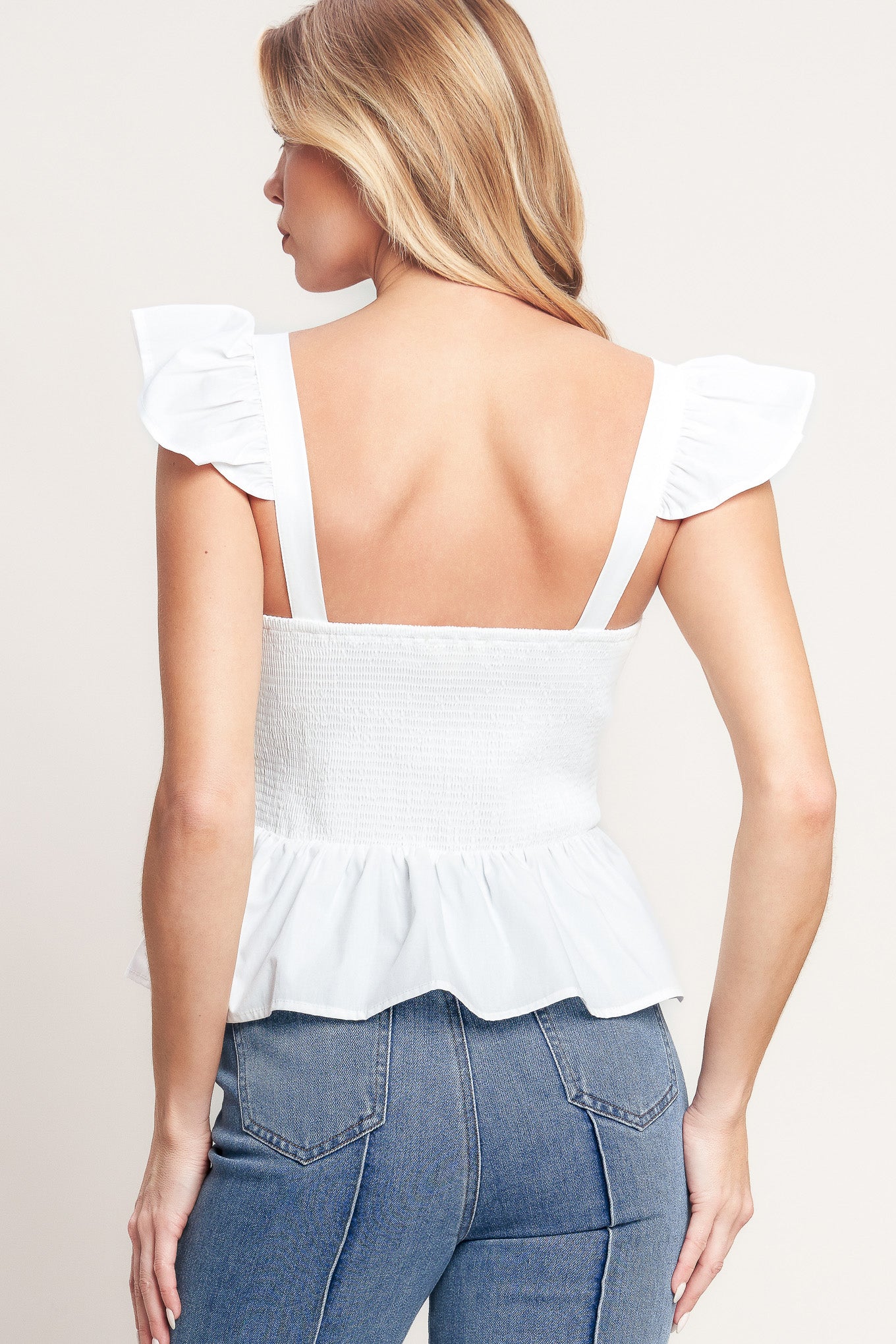 A solid woven top featuring sweetheart neckline, short ruffle sleeve, front embroidery detail, peplum and smocked back bodice

Details:

Self: 100% Cotton Lining : 100% Polyester

Size & Fit

-Model is 5`8" And Wearing Size Small
-Measurements Taken From Size Small
-Approx. Length: 21"