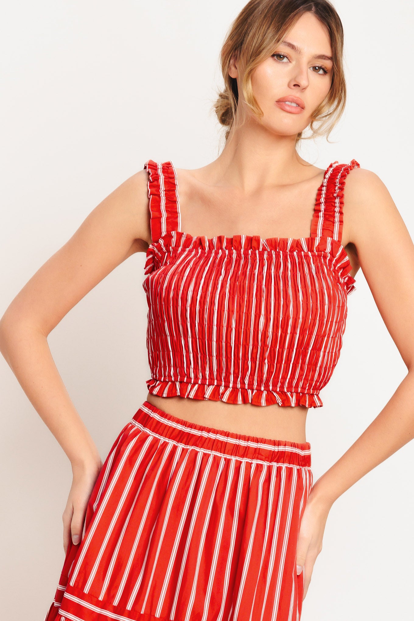A striped woven top featuring straight ruffled neckline, straps and smocked bodice. Matching skirt IK7744T

Details:

Self: 100% Cotton

Lining: 100% Polyester

Size & Fit

-Model is 5`8" And Wearing Size Small
-Measurements Taken From Size Small
-Approx. Length: 17"
