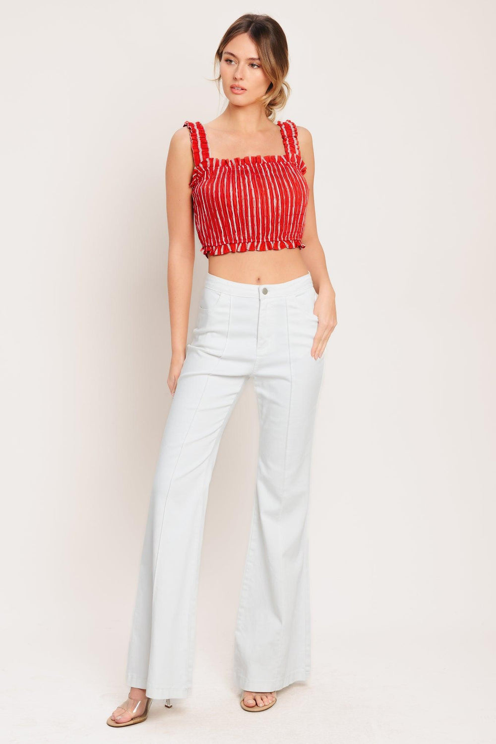 A striped woven top featuring straight ruffled neckline, straps and smocked bodice. Matching skirt IK7744T

Details:

Self: 100% Cotton

Lining: 100% Polyester

Size & Fit

-Model is 5`8" And Wearing Size Small
-Measurements Taken From Size Small
-Approx. Length: 17"