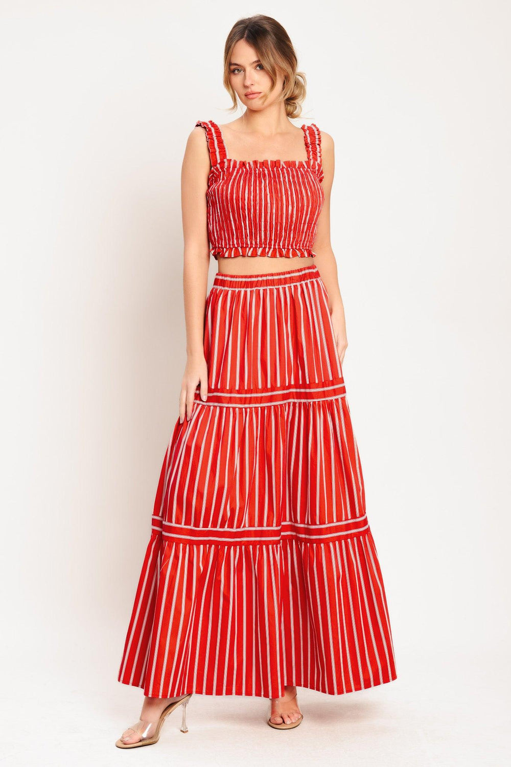 A striped woven top featuring straight ruffled neckline, straps and smocked bodice. Matching skirt IK7744T

Details:

Self: 100% Cotton

Lining: 100% Polyester

Size & Fit

-Model is 5`8" And Wearing Size Small
-Measurements Taken From Size Small
-Approx. Length: 17"