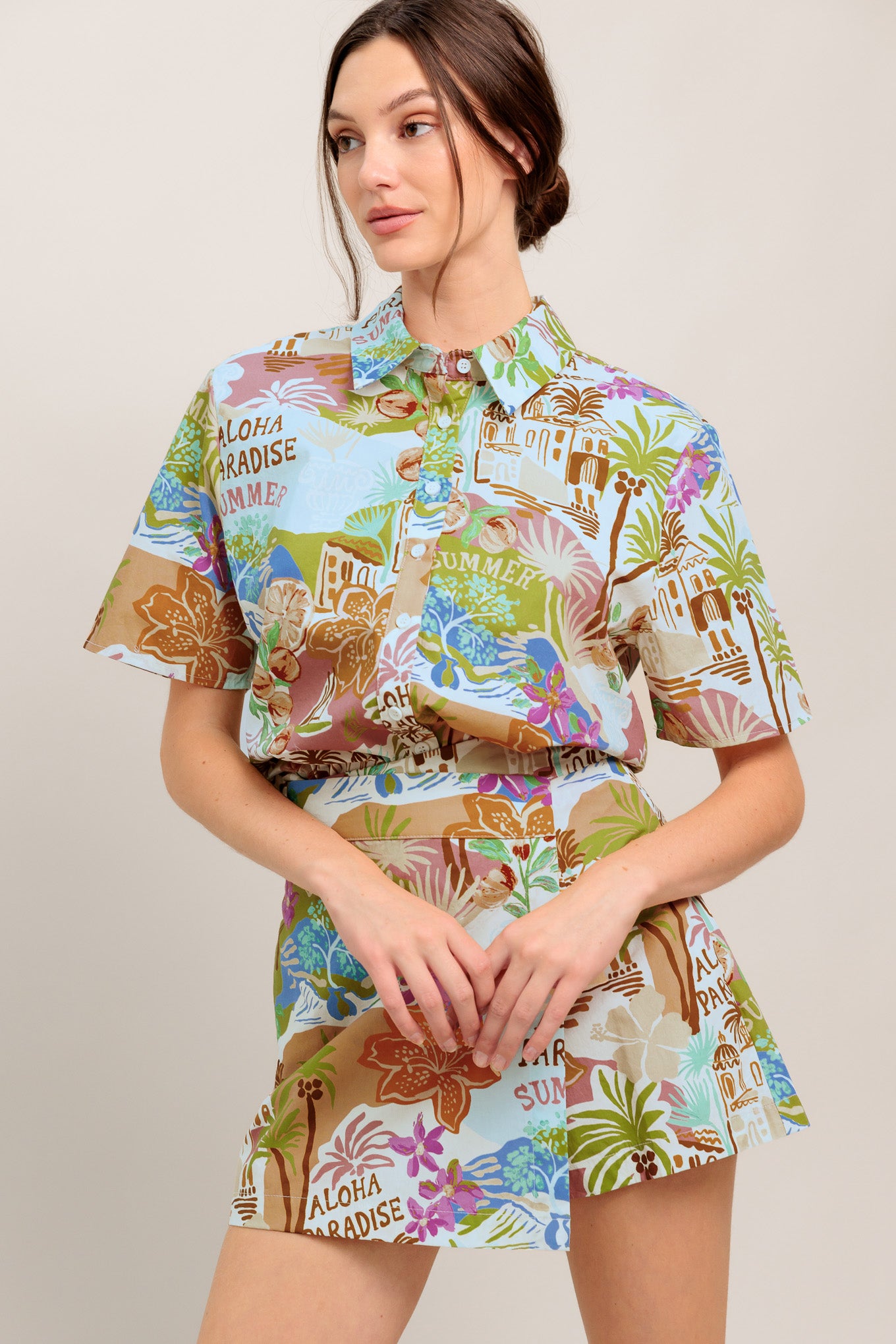 A printed woven top featuring collar, short sleeve and button down closure

Details:

Self: 100% Cotton

Size & Fit

- Model is 5`8" And Wearing Size Small
- Measurements Taken From Size Small