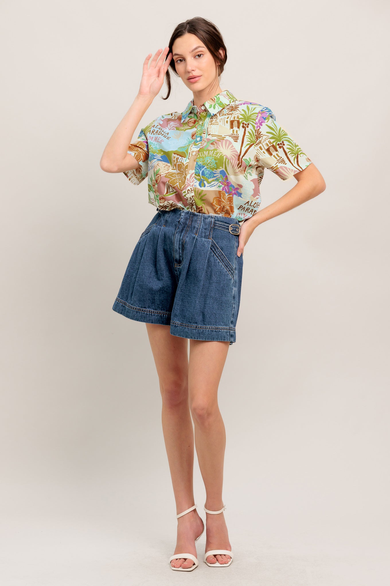 A printed woven top featuring collar, short sleeve and button down closure

Details:

Self: 100% Cotton

Size & Fit

- Model is 5`8" And Wearing Size Small
- Measurements Taken From Size Small