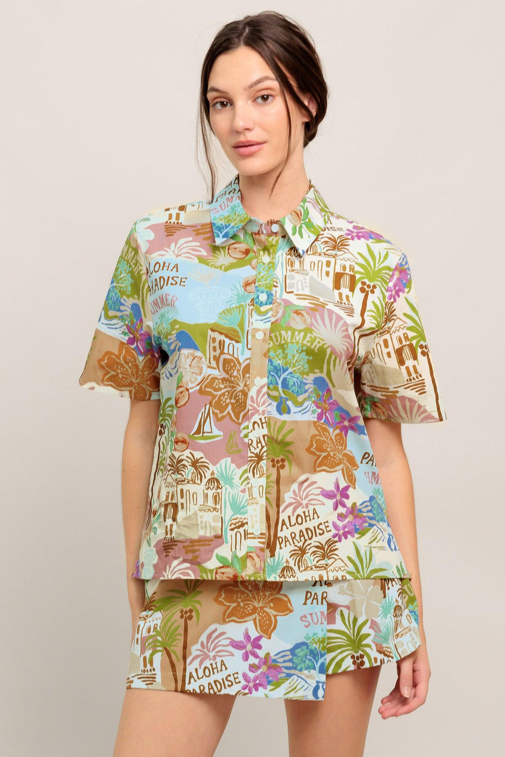 A printed woven top featuring collar, short sleeve and button down closure

Details:

Self: 100% Cotton

Size & Fit

- Model is 5`8" And Wearing Size Small
- Measurements Taken From Size Small