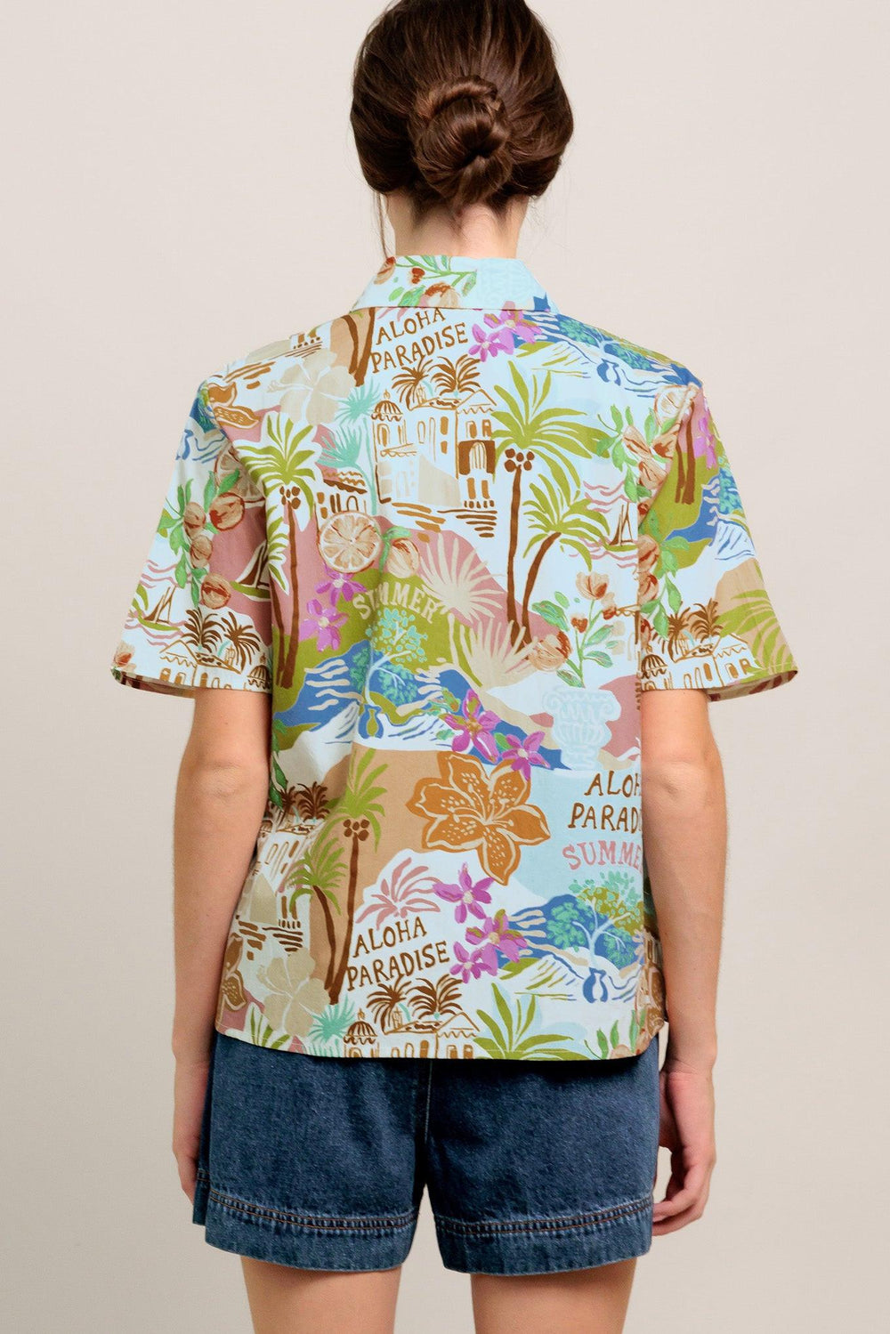A printed woven top featuring collar, short sleeve and button down closure

Details:

Self: 100% Cotton

Size & Fit

- Model is 5`8" And Wearing Size Small
- Measurements Taken From Size Small
