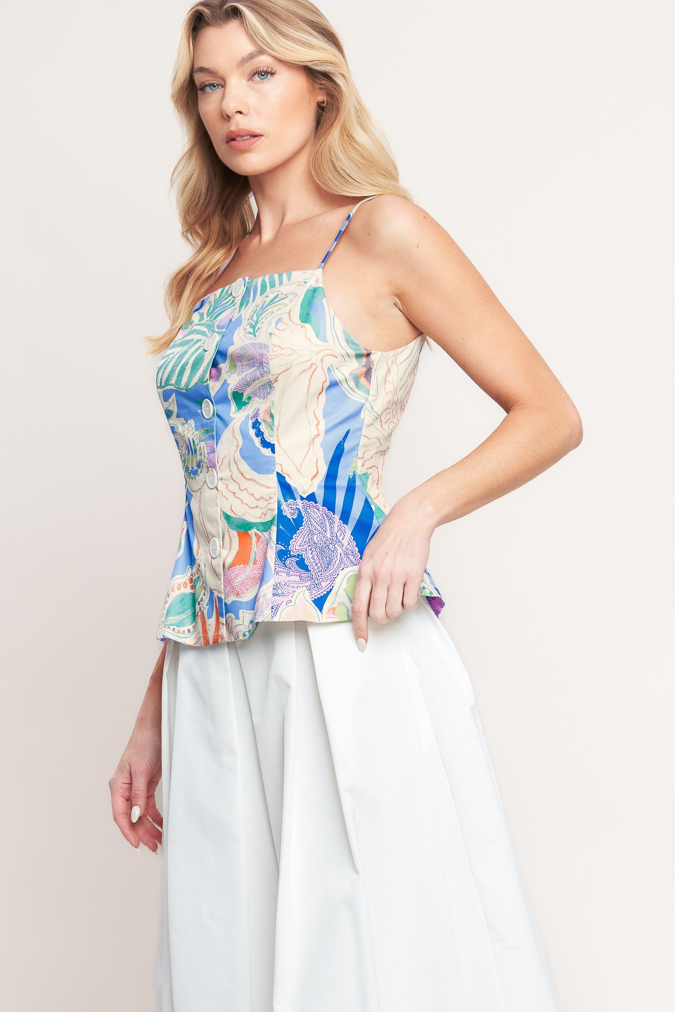 A printed woven top featuring a straight neckline, straps, front button-down, and peplum hem

Details:

Self : 100% Cotton

Lining : 100% Polyester

Size & Fit

-Model is 5`8" And Wearing Size Small
-Measurements Taken From Size Small
-Approx. Length: 22"