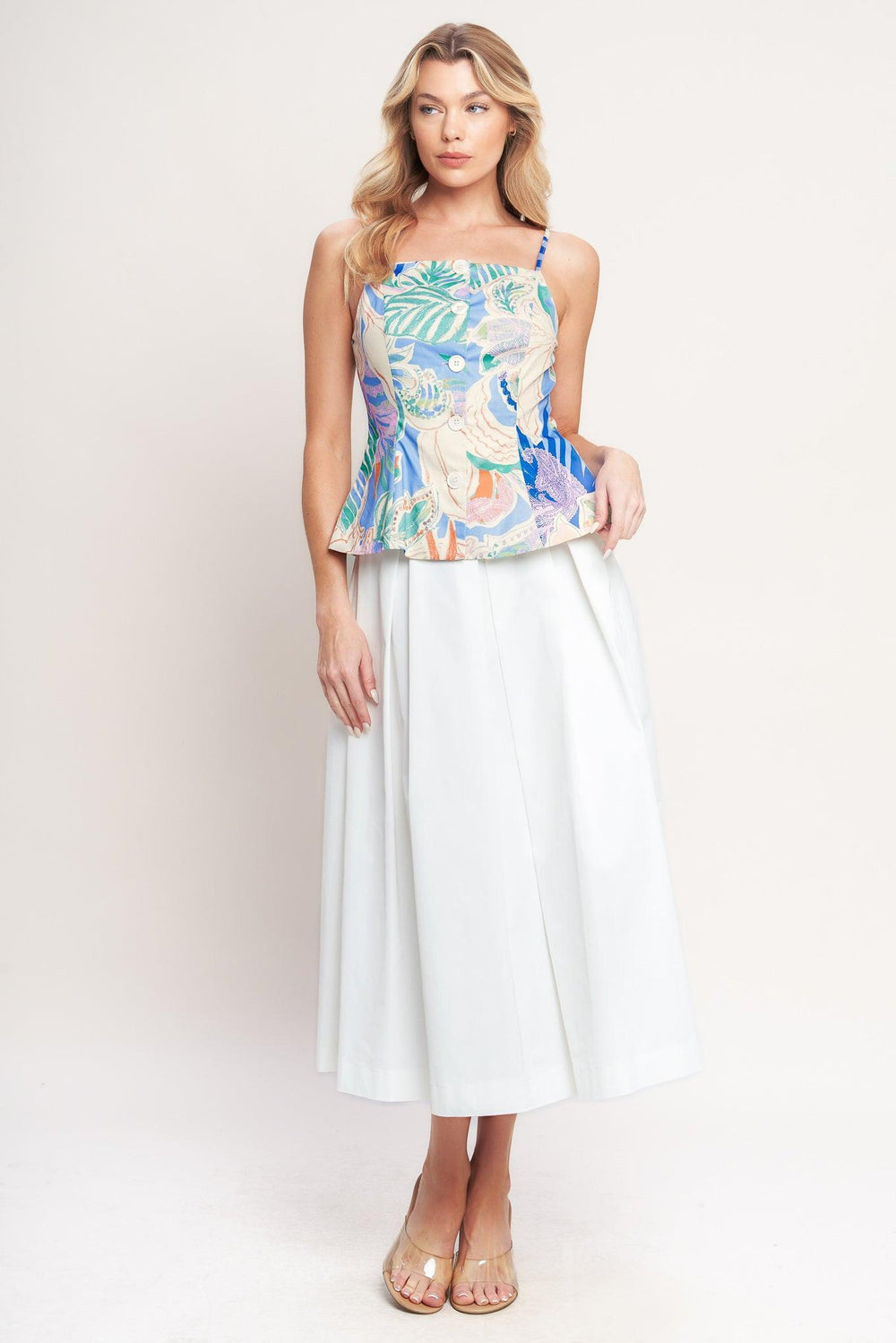 A printed woven top featuring a straight neckline, straps, front button-down, and peplum hem

Details:

Self : 100% Cotton

Lining : 100% Polyester

Size & Fit

-Model is 5`8" And Wearing Size Small
-Measurements Taken From Size Small
-Approx. Length: 22"