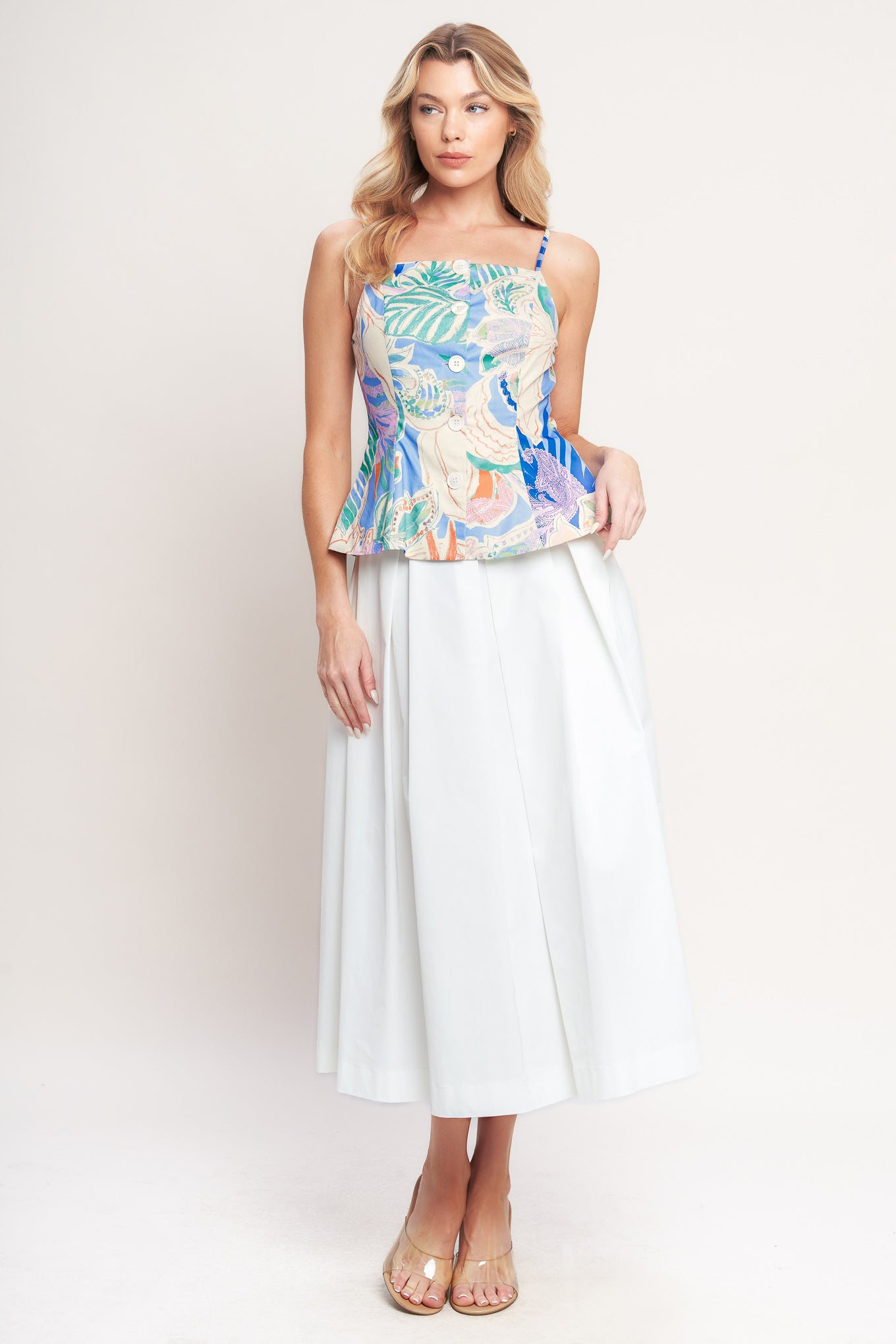 A printed woven top featuring a straight neckline, straps, front button-down, and peplum hem

Details:

Self : 100% Cotton

Lining : 100% Polyester

Size & Fit

-Model is 5`8" And Wearing Size Small
-Measurements Taken From Size Small
-Approx. Length: 22"