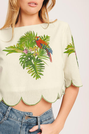 A printed woven crop top featuring round neckline, short sleeve, scallop edge and back neck button closure. Matching skirt IK7753T

Details:

Self: 50% Cotton 20% Rayon 20% Polyester 10% Linen

Lining: 100% Polyester

Size & Fit

-Model is 5`8" And Wearing Size Small
-Measurements Taken From Size Small
-Approx. Length: 17"