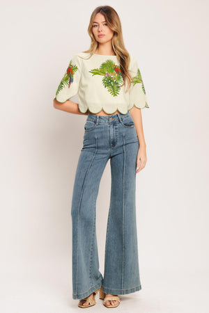A printed woven crop top featuring round neckline, short sleeve, scallop edge and back neck button closure. Matching skirt IK7753T

Details:

Self: 50% Cotton 20% Rayon 20% Polyester 10% Linen

Lining: 100% Polyester

Size & Fit

-Model is 5`8" And Wearing Size Small
-Measurements Taken From Size Small
-Approx. Length: 17"
