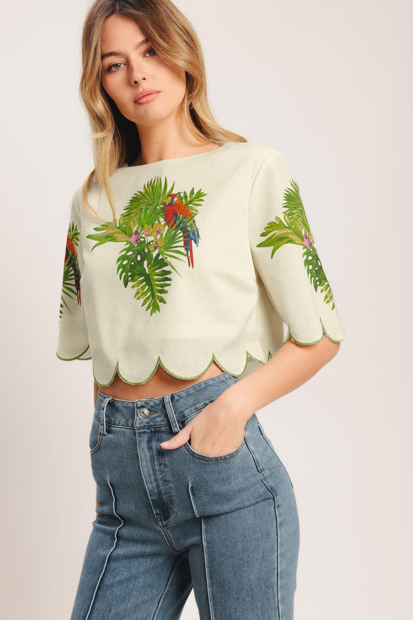 A printed woven crop top featuring round neckline, short sleeve, scallop edge and back neck button closure. Matching skirt IK7753T

Details:

Self: 50% Cotton 20% Rayon 20% Polyester 10% Linen

Lining: 100% Polyester

Size & Fit

-Model is 5`8" And Wearing Size Small
-Measurements Taken From Size Small
-Approx. Length: 17"