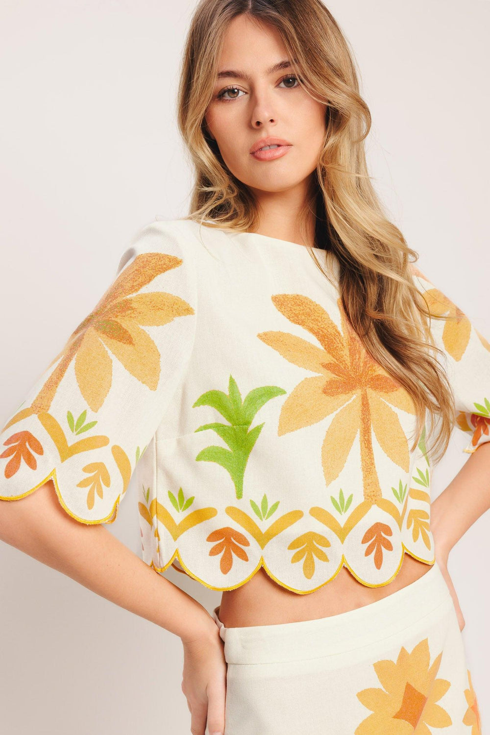 A printed woven crop top featuring round neckline, 3/4 sleeve with scalloped finish and back neck button closure

Details:

Self: 50% Cotton 20% Rayon 20% Polyester 10% Linen

Lining: 100% Polyester

Size & Fit

-Model is 5`8" And Wearing Size Small
-Measurements Taken From Size Small
-Approx. Length: 18"