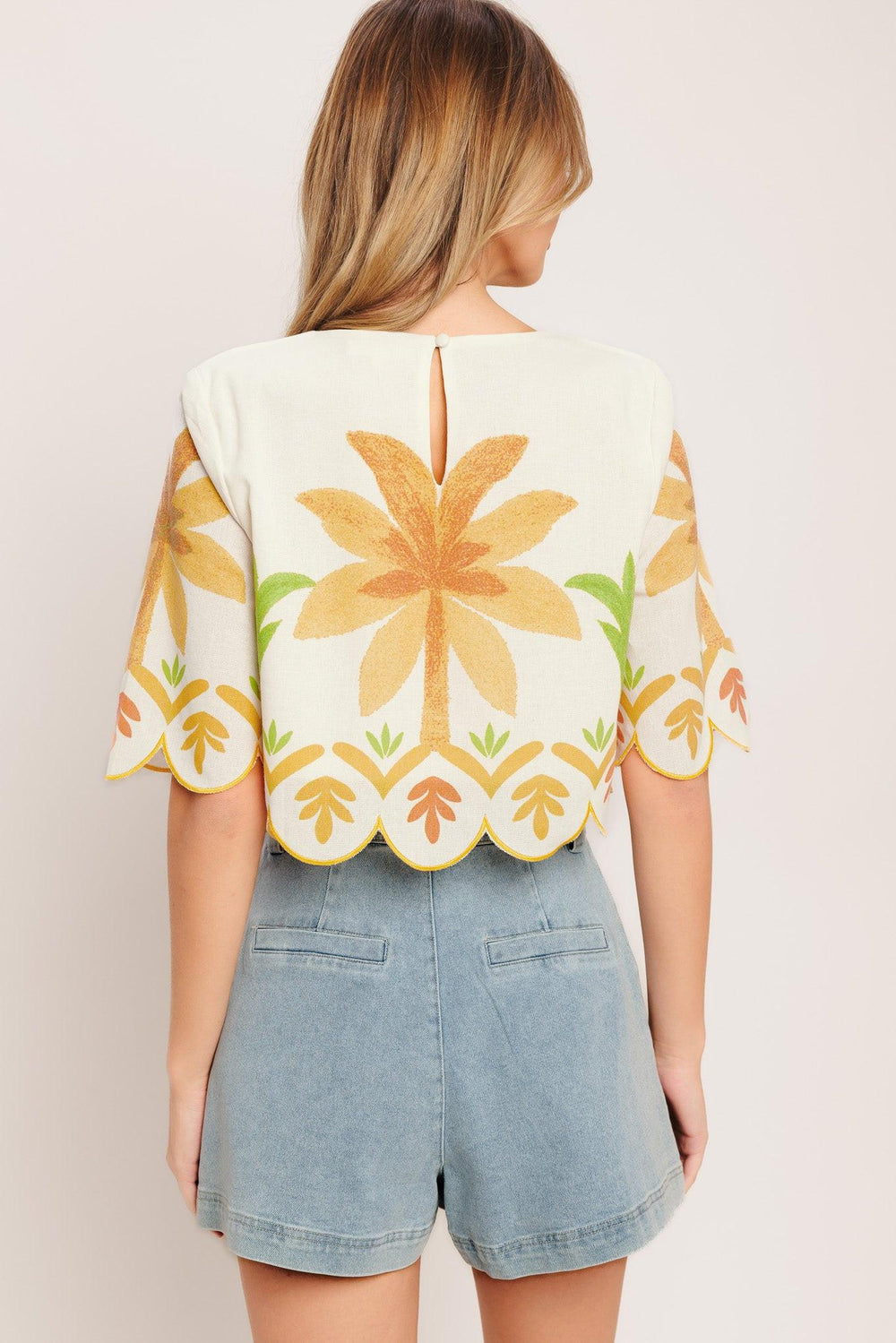 A printed woven crop top featuring round neckline, 3/4 sleeve with scalloped finish and back neck button closure

Details:

Self: 50% Cotton 20% Rayon 20% Polyester 10% Linen

Lining: 100% Polyester

Size & Fit

-Model is 5`8" And Wearing Size Small
-Measurements Taken From Size Small
-Approx. Length: 18"