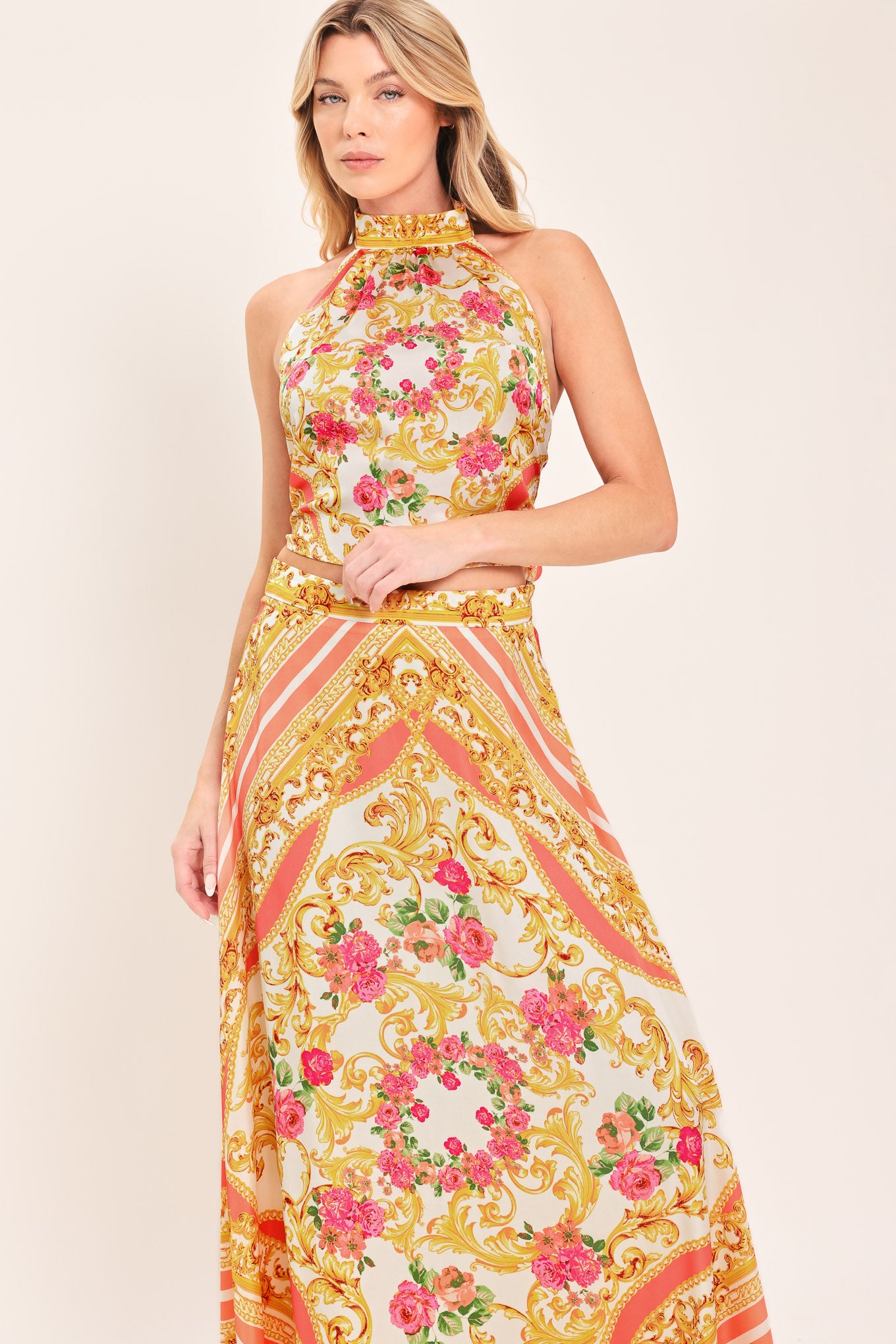 Woman wearing a floral and gold baroque patterned crop top ad skirt set | Flying Tomato