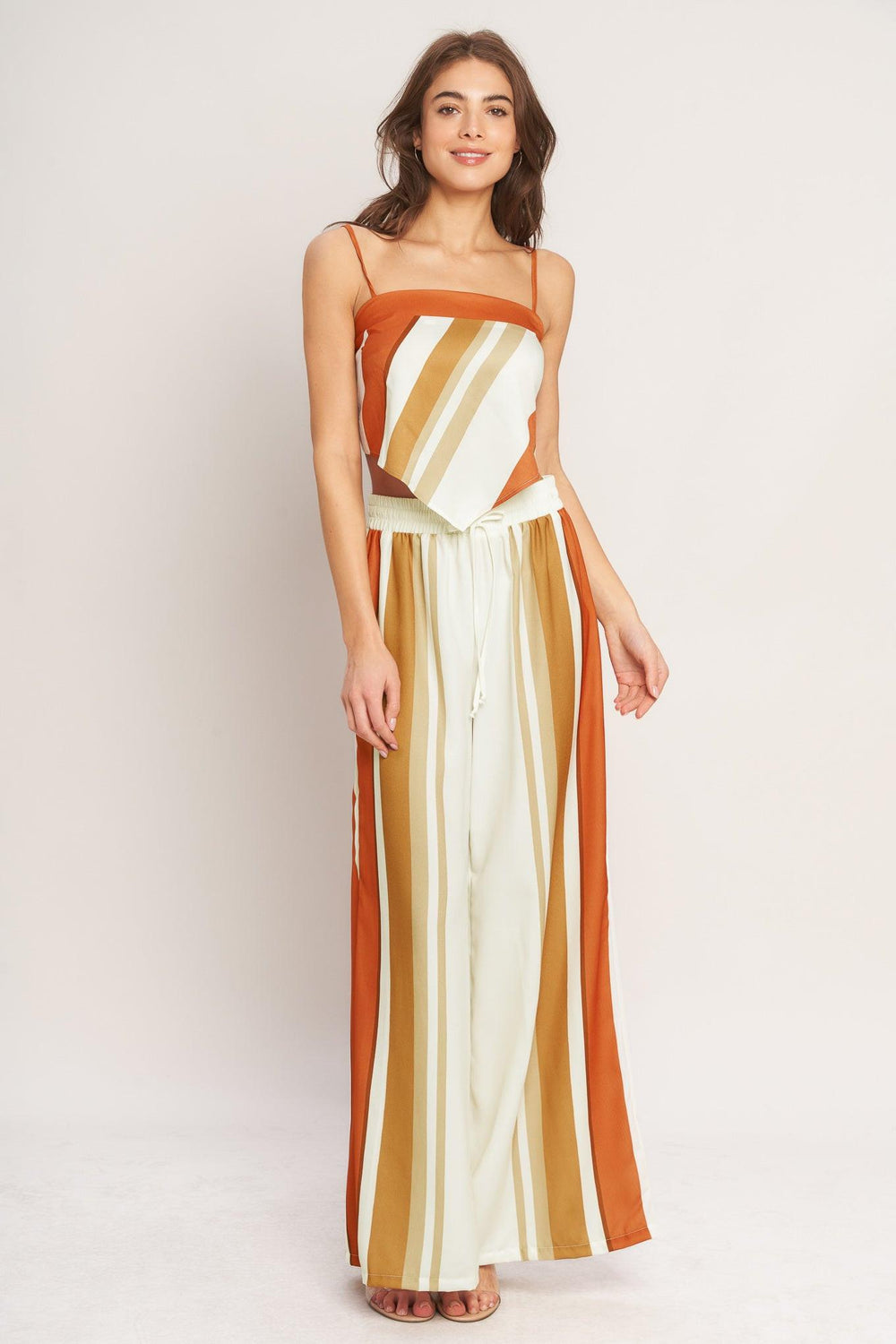 A printed woven scarf top featuring straight neckline, straps and tie back. 