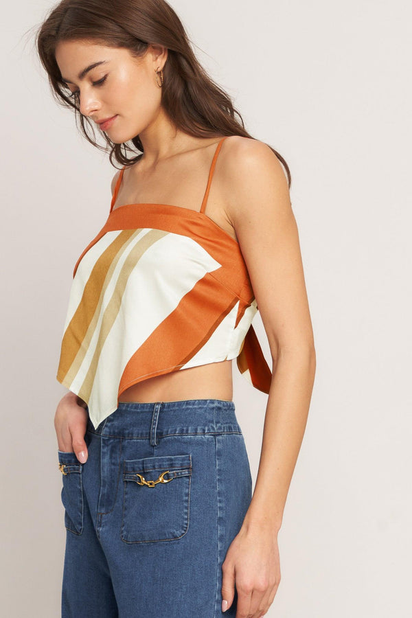 A printed woven scarf top featuring straight neckline, straps and tie back. 