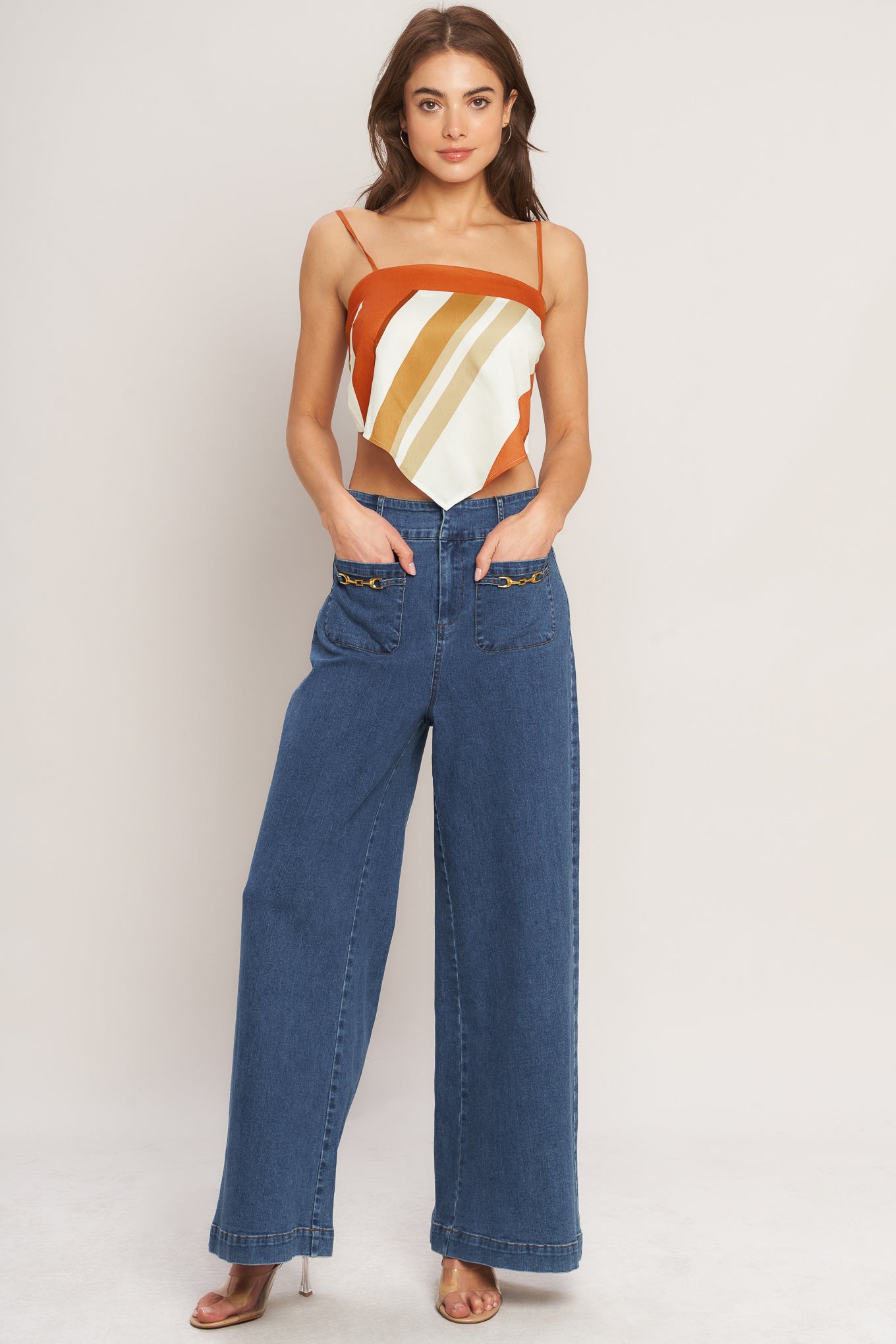 A printed woven scarf top featuring straight neckline, straps and tie back. 