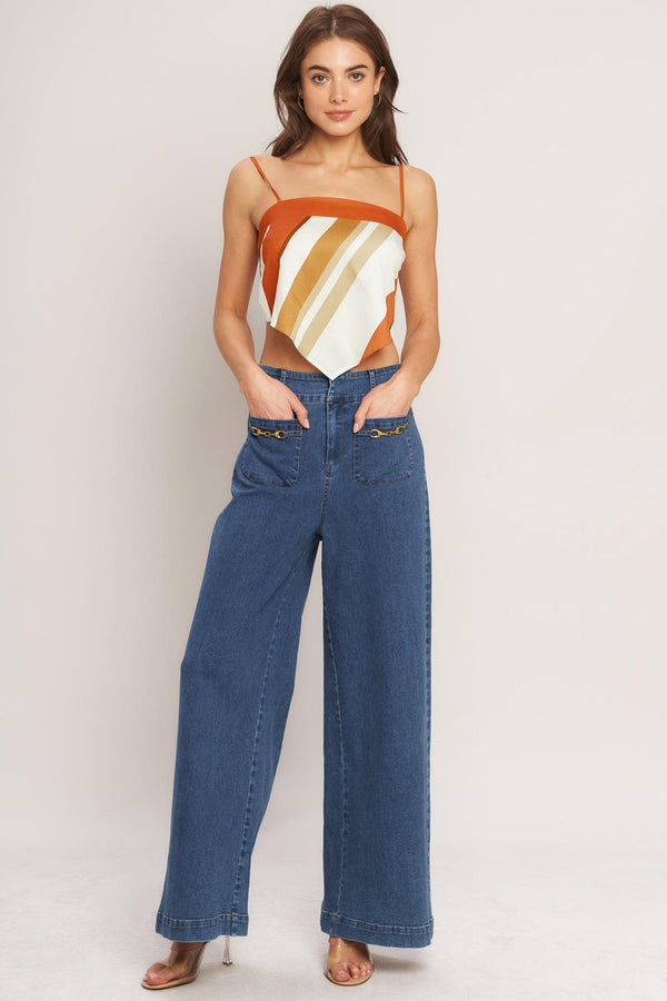 A printed woven scarf top featuring straight neckline, straps and tie back. 