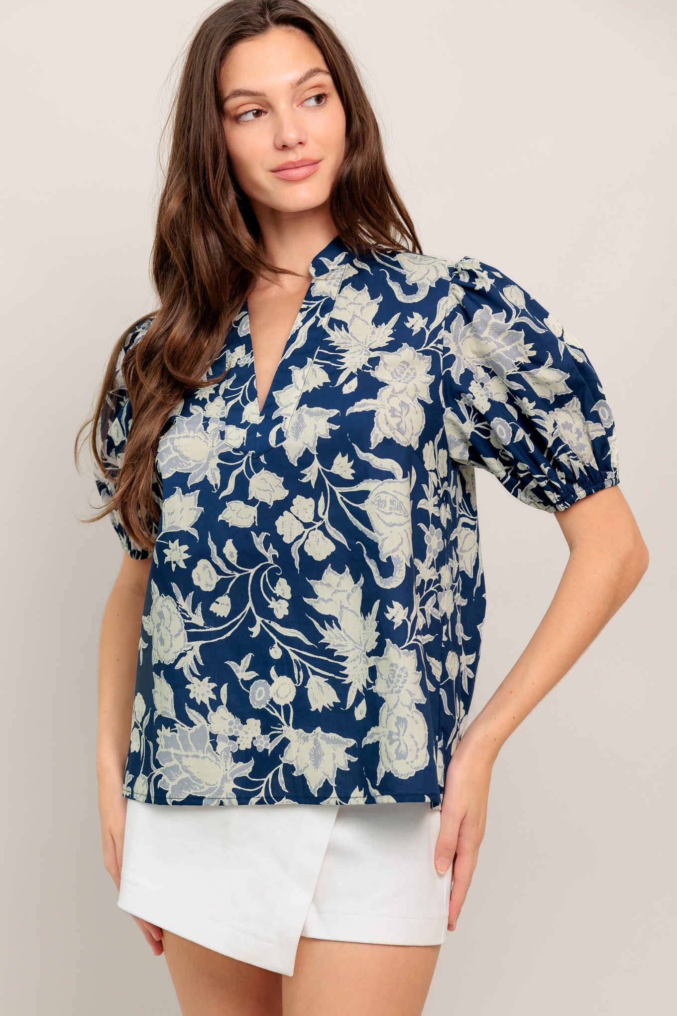 Navy floral V-neck blouse with soft puff sleeves and a relaxed, polished fit

Details:

Self: 100% Cotton

Size & Fit

- Model is 5`8" And Wearing Size Small
- Measurements Taken From Size Small
- Approx. Length: 24"