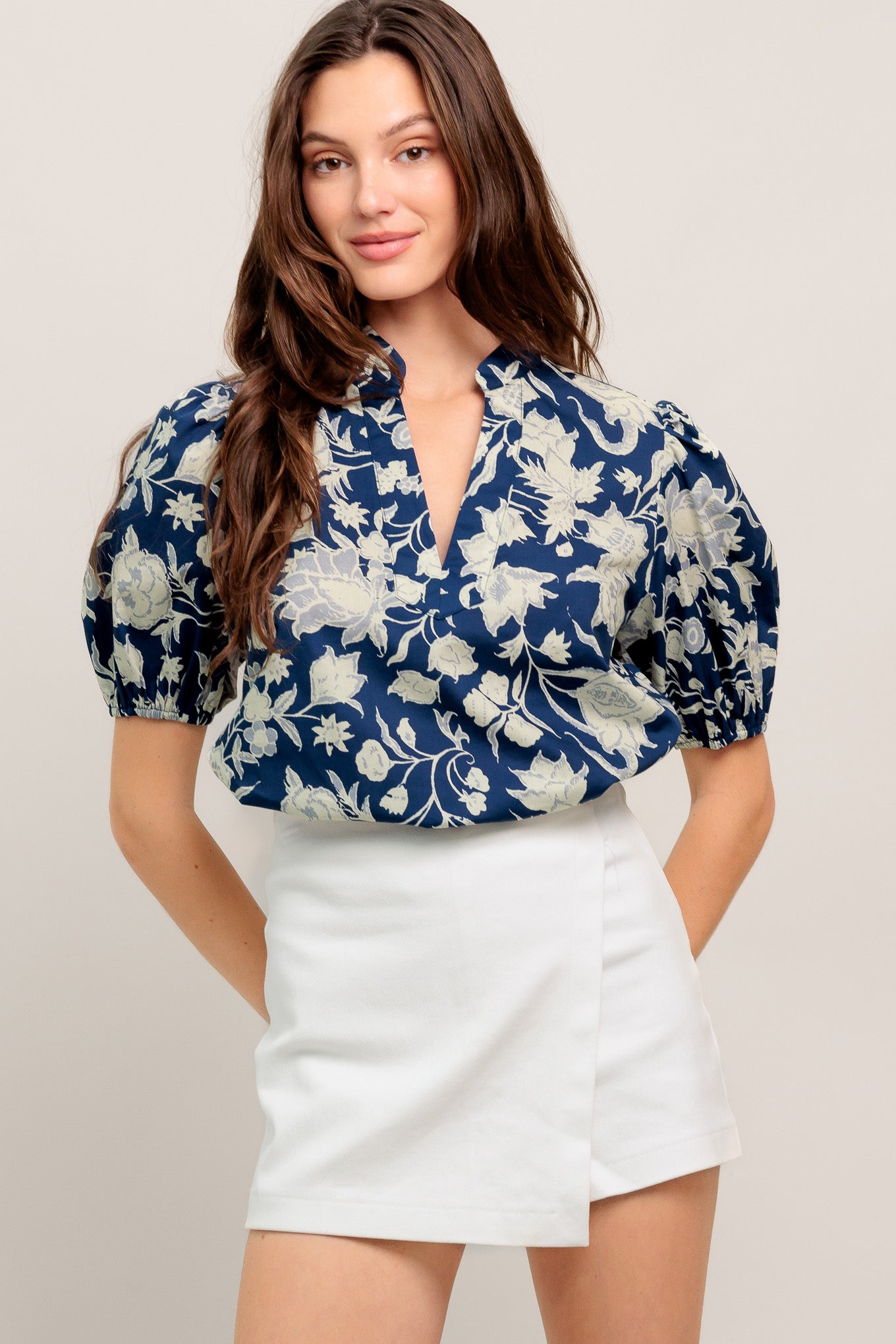 Navy floral V-neck blouse with soft puff sleeves and a relaxed, polished fit

Details:

Self: 100% Cotton

Size & Fit

- Model is 5`8" And Wearing Size Small
- Measurements Taken From Size Small
- Approx. Length: 24"