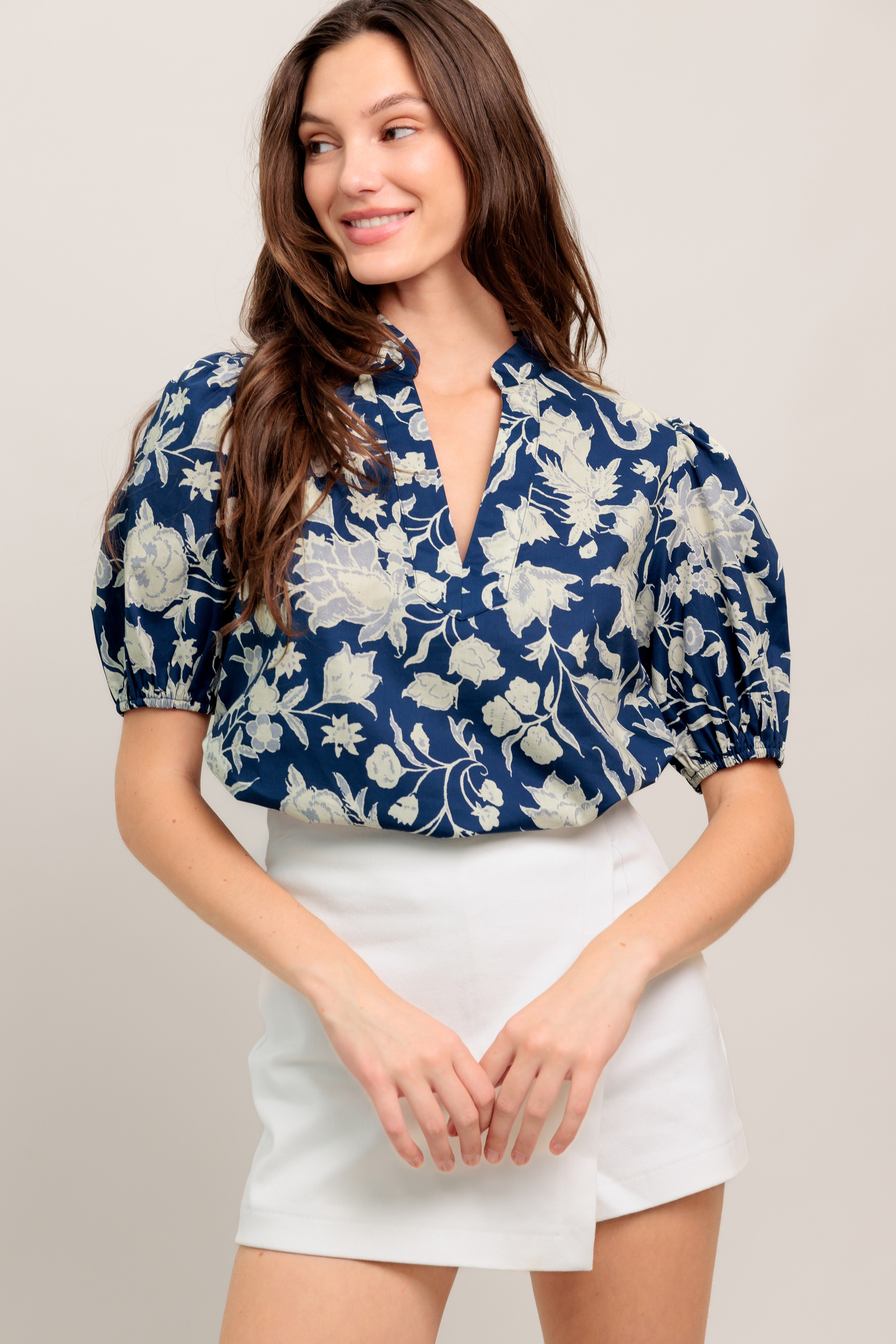 Navy floral V-neck blouse with soft puff sleeves and a relaxed, polished fit

Details:

Self: 100% Cotton

Size & Fit

- Model is 5`8" And Wearing Size Small
- Measurements Taken From Size Small
- Approx. Length: 24"